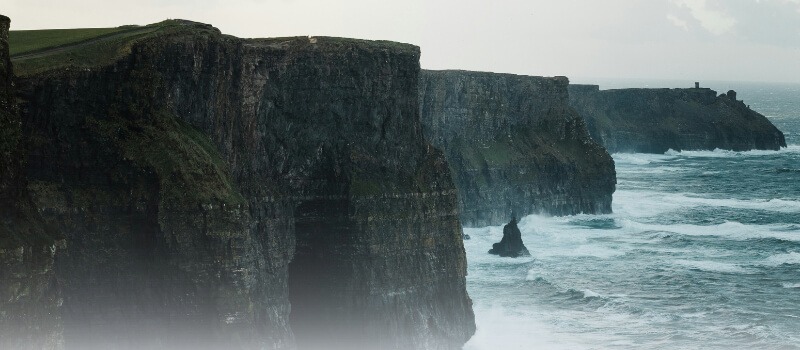 Majestic cliffs and ocean waves symbolizing the strength, growth, and impact of private capital