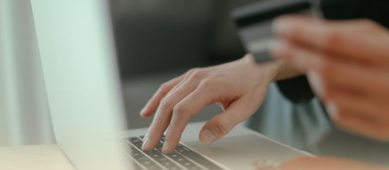 A person making an online payment with a credit card, symbolizing the rise of fintech in Indian healthcare financing.