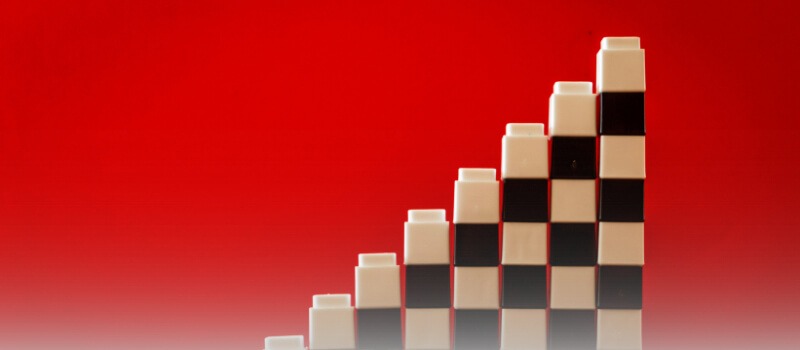 Building blocks stacked to resemble a growing graph, illustrating the concept of compounding returns in private market investments over a 10-year horizon