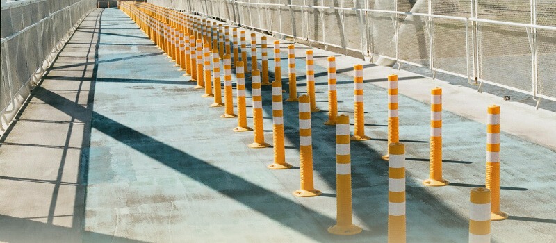 A long line of orange and white traffic bollards, symbolizing the growing pathway and opportunities in India's manufacturing sector for private equity investment