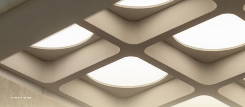 Geometric ceiling lights symbolizing clarity, structure, and global focus converging on India.
