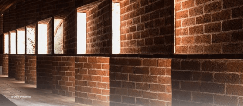 Brick wall with patterned windows, representing stability and structural shifts in India’s private markets.