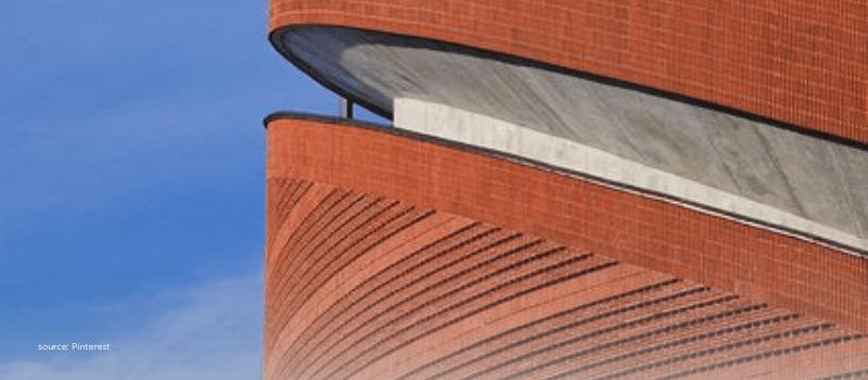 Modern curved terracotta facade conveying deal flow scale and structured secondaries reshaping exits in India.