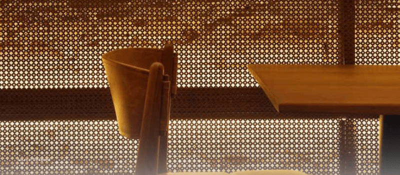 Minimalist chair and perforated screen in warm light, framing smarter HNI portfolio choices.
