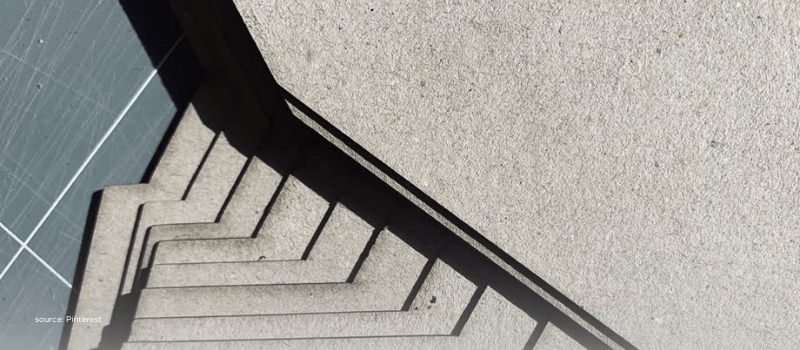 Stacked grey card layers in sharp light, representing capital layers in secondaries.