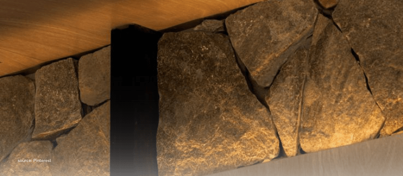 Warm-lit stone wall detail, suggesting new foundations from retail capital and tech vehicles.