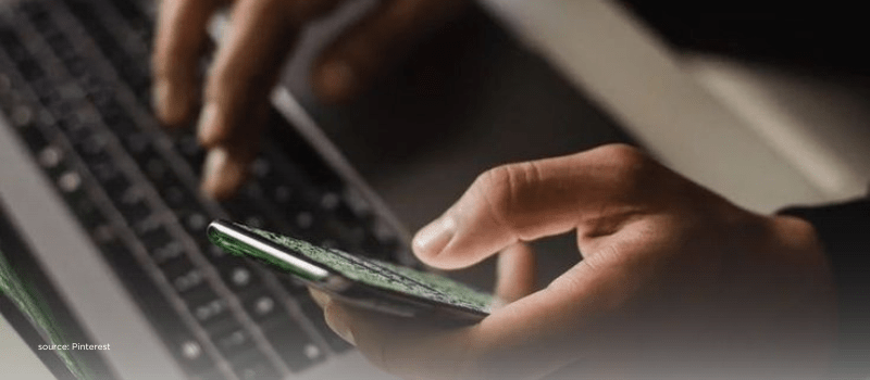 Hands using phone and laptop—signal capital flows and AI valuations 2025