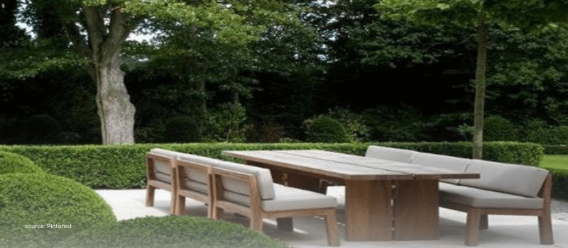 Minimal outdoor table and benches, suggesting scaled, institutional venture platforms.