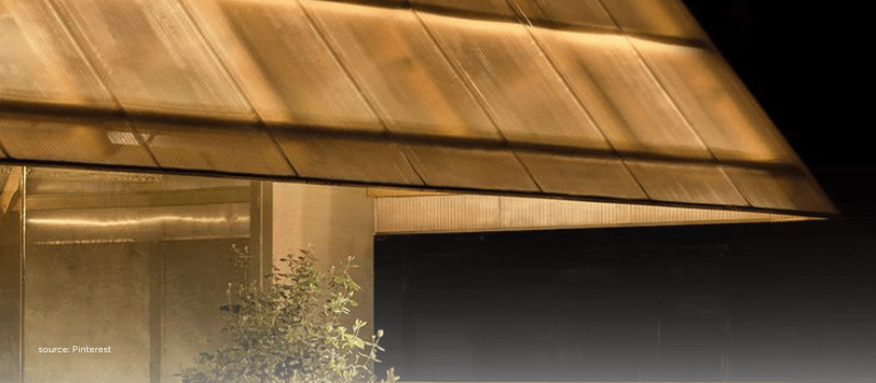 Warm-lit glass awning over entry, spotlighting India’s focus sectors