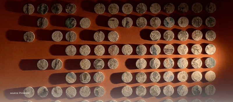 Ordered coins on a wall evoke structure, governance and control-focused buyouts.
