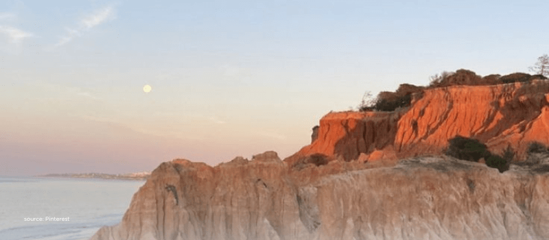 Coastal cliffs above calm water representing controlled liquidity in semi-liquid funds