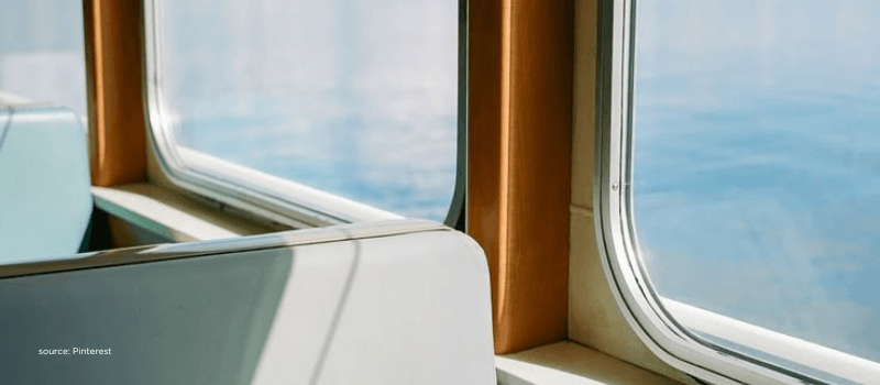Train window view over water, reflecting movement, product building, and global connectivity.