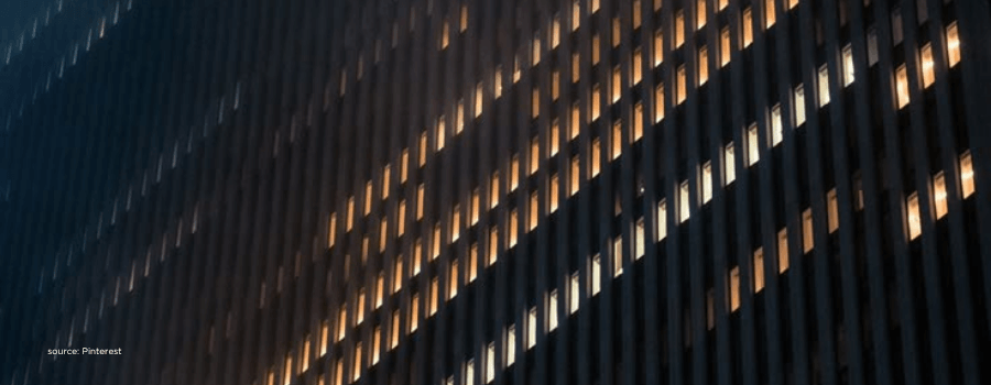 Illuminated office building at night representing global institutional capital flows