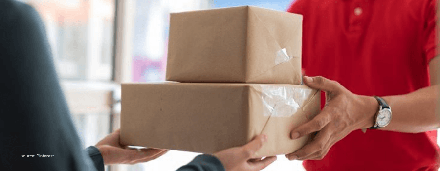 Delivery person handing parcels representing quick commerce growth in India