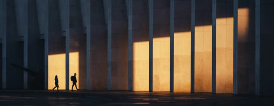 Two silhouettes walking past illuminated pillars, symbolizing paths through an IPO structure
