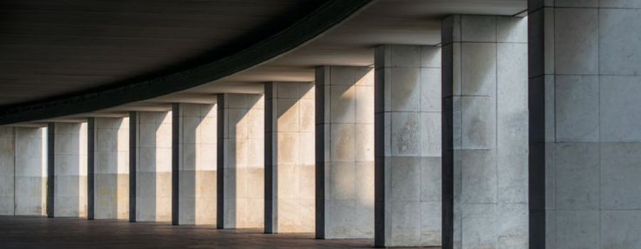 Row of concrete pillars in light and shadow, representing concentrated PE capital flows