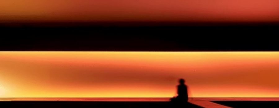 A seated silhouette against a glowing horizon, representing investor certainty over uncertainty