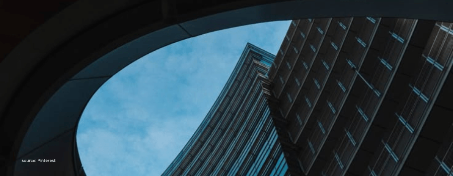 Curved glass facade against rising towers, representing India's growth trajectory